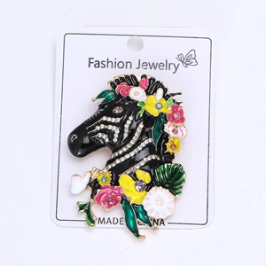 Detail of enamel zebra brooch with inlaid colorful rhinestones and floral pattern