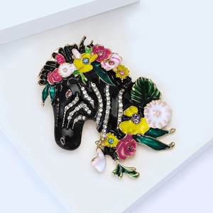 Zebra head enamel brooch with colorful flowers and rhinestones on white geometric stand