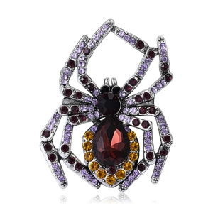 Vintage silver spider brooch with large red pear-shaped gem and multicolor crystals