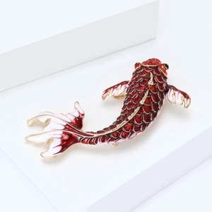 Detailed macro view of enamel koi fish brooch with red crystals and gold-tone finish