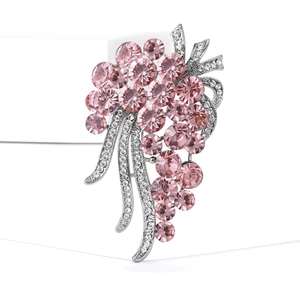 Exquisite pink rhinestone grape brooch with silver vine detail on white background