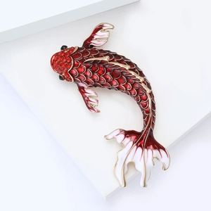 Detailed view of luxury koi fish brooch with red enamel scales and gold metal edges