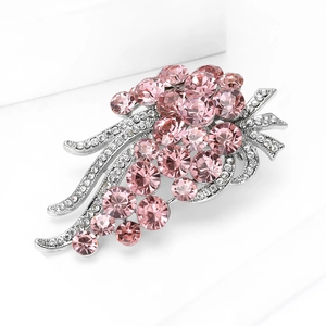 Detailed macro view of silver flower brooch with pink rhinestones and white crystals