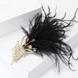 Macro detail of luxury feather brooch with colorful gemstones and black ostrich feathers