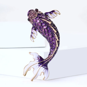 Exquisite koi carp brooch with purple enamel and crystals on a white pedestal