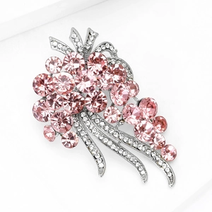 Close-up of elegant flower brooch with pink rhinestones and silver metal base