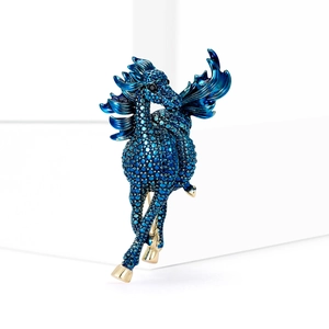 Sparkling blue crystal pegasus horse brooch with gold accents in dynamic flying pose