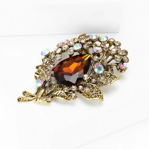 Close-up of vintage flower brooch with amber crystal teardrop and AB rhinestones