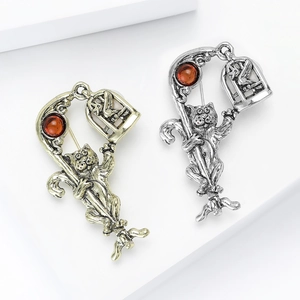 Retro cat brooch set in antique gold and silver with rhinestones and birdcage charms