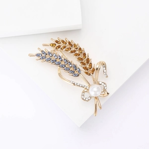 Detailed macro view of wheat brooch with colorful crystals and elegant white pearl