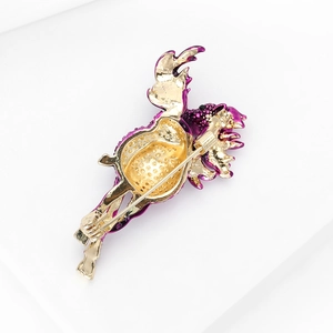 Detail view of golden flamingo brooch back showing secure pin and hollowed alloy base
