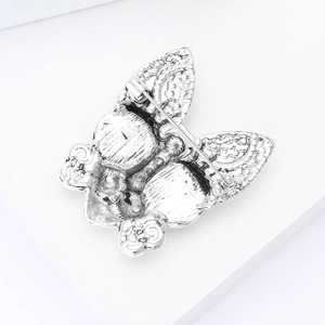 Detailed back view of silver vintage butterfly brooch showing metal texture and pin buckle