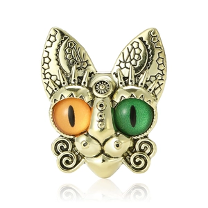 Golden cat brooch with heterochromia orange and green eyes and geometric sun patterns