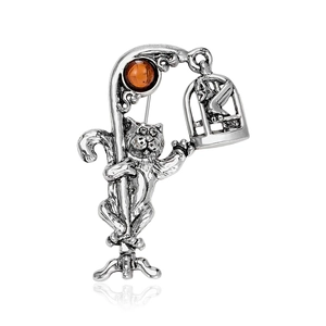 Vintage silver cat brooch with amber gemstone featuring a street lamp and birdcage design
