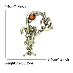 Retro cat brooch with amber gemstone and birdcage detail in vintage gold finish