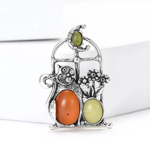 Detailed retro cat brooch featuring orange gemstone and vintage silver window frame