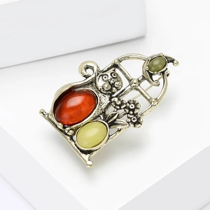Detailed view of vintage alloy cat brooch with colorful resin gems and retro finish