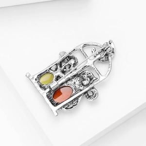 Macro shot of vintage silver alloy cat brooch showing the back pin and stone inlay details
