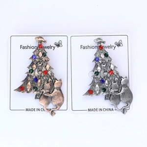 Detailed close-up of antique gold and silver Christmas tree brooches with rhinestones