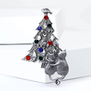 Close-up of vintage silver Christmas tree brooch with colorful rhinestones and cats