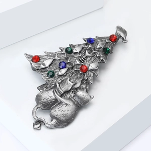 Detail of vintage silver Christmas tree brooch with colorful rhinestones and cat figures