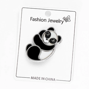 Detail of cute panda enamel brooch with black rhinestones on a display card