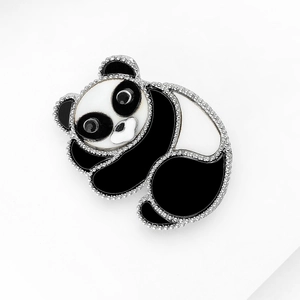 Detailed view of cute panda brooch with black and white enamel and silver metal edges