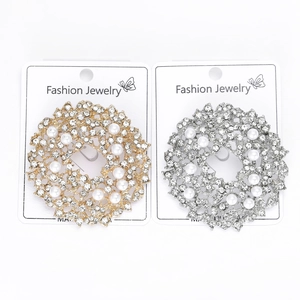 Detail of sun flower brooches with clear rhinestones and pearls on display cards