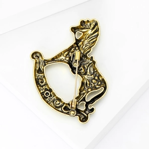Vintage enamel rocking horse brooch in antique gold finish showing the back pin detail