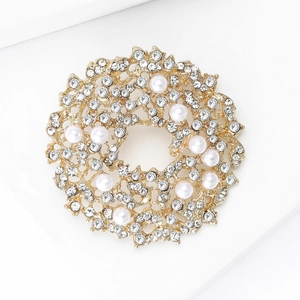 Elegant gold sunburst wreath brooch with sparkling white rhinestones and pearls