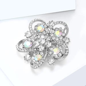 Detailed close-up of a silver floral brooch with sparkling rhinestones and AB crystals
