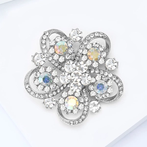 Detail shot of hollow flower brooch with sparkling rhinestones and rainbow AB crystals