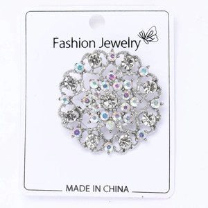 Close-up of circular lace hollow brooch with silver alloy and clear AB rhinestones