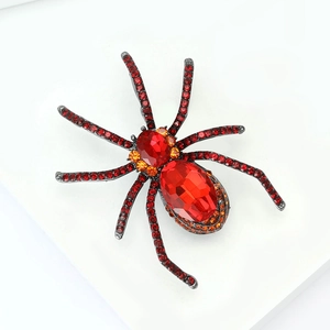 Close-up of vintage spider brooch with red rhinestones and gothic black metal finish