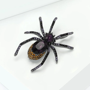 Macro shot of spider brooch with purple gemstones and black rhinestones detailing