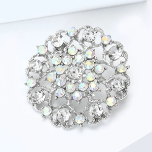 Elegant silver sunflower brooch with sparkling AB rhinestones on a minimalist white stand