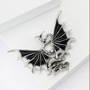 Detailed macro view of Western dragon brooch with black and white enamel wings and scales