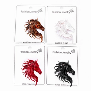 Close-up of four-color horse head pins in alloy with enamel finish on display cards