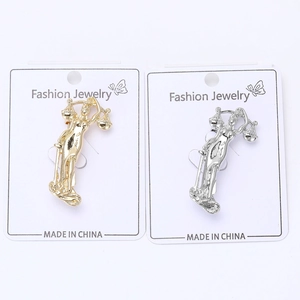 Detail of gold and silver Goddess of Justice pins with scales and sword on display cards