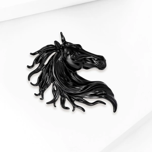 Macro shot showing detail of a glossy black horse head brooch with sleek mane curves