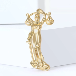 Golden Lady Justice brooch with balance and sword on a minimalist white background