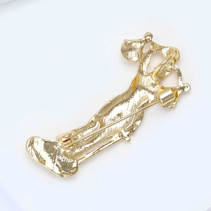 Detailed view of the golden brooch back featuring a secure long pin safety clasp closure