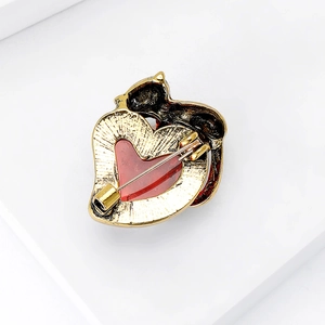 Detailed back view of a vintage cat brooch showing the secure swivel pin clasp and texture
