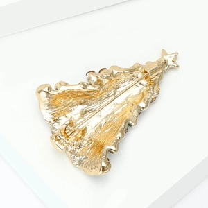 Back view of gold Christmas tree brooch showing the secure pin closure and metal texture