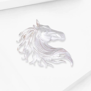 Detailed relief of horse head brooch in pearlescent white finish with sleek silver tones