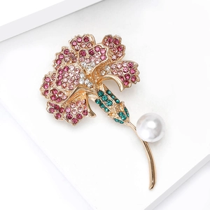Detailed view of carnation brooch with colorful rhinestones and white pearl accent