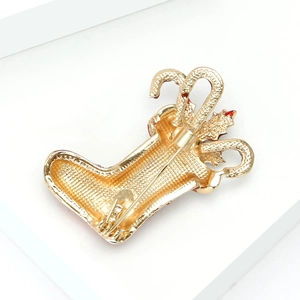 Golden Christmas stocking brooch with rhinestones and enamel candy cane details