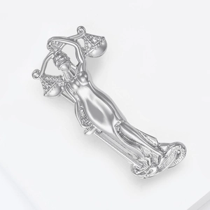 Macro shot of silver Justice Goddess brooch with scales and blindfold details