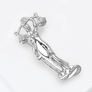 Macro shot of silver Justice Goddess brooch showing scales and secure back pin