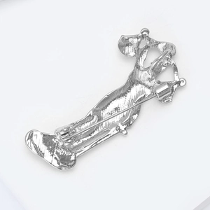 Detailed back view of silver alloy brooch showing secure pin fastener and metal texture
